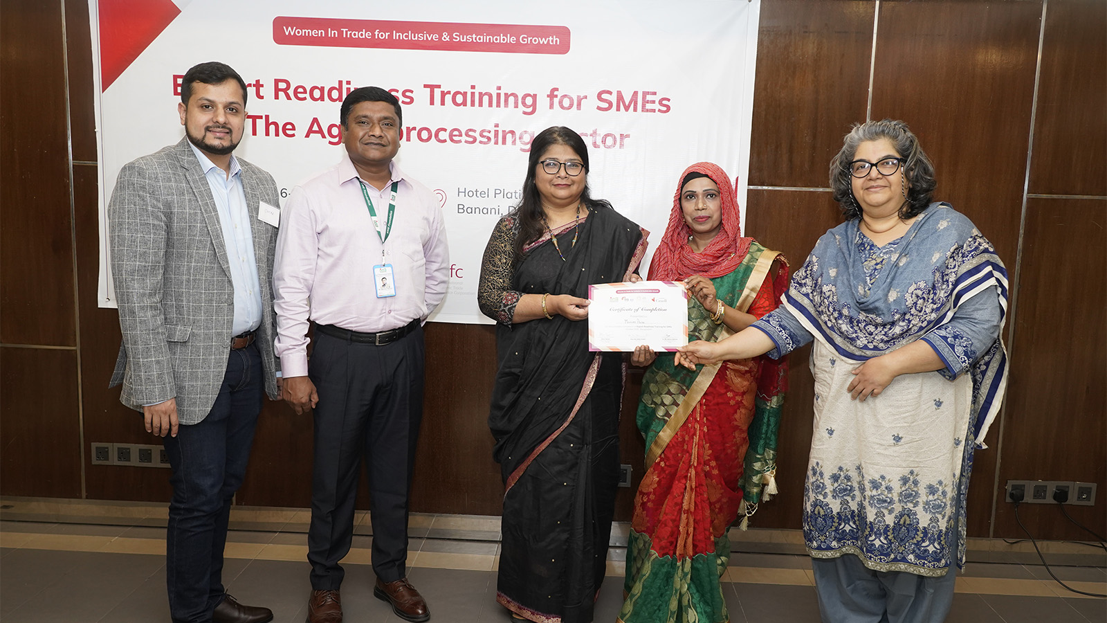 A participant at the event receiving certificate from the trainers