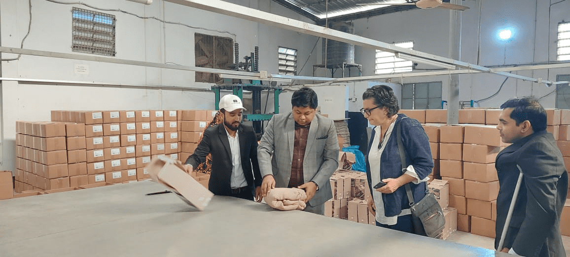 Ms. Campbel With the Founder & Staff During a Factory Visit