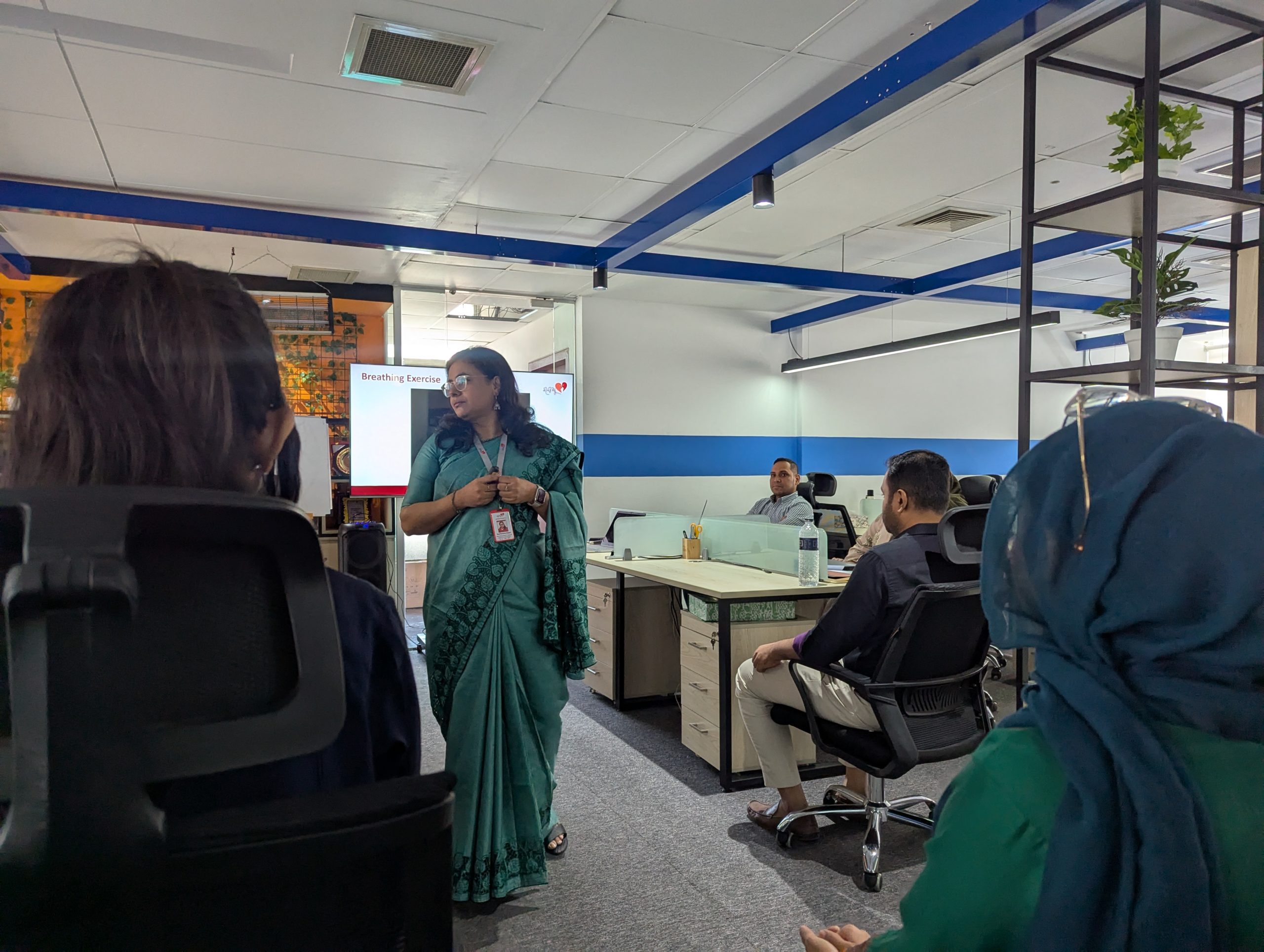Kazi Rumana Haque, guiding the team through a series of discussions and activities centered around empathy, trust, and inclusion in the workplace.